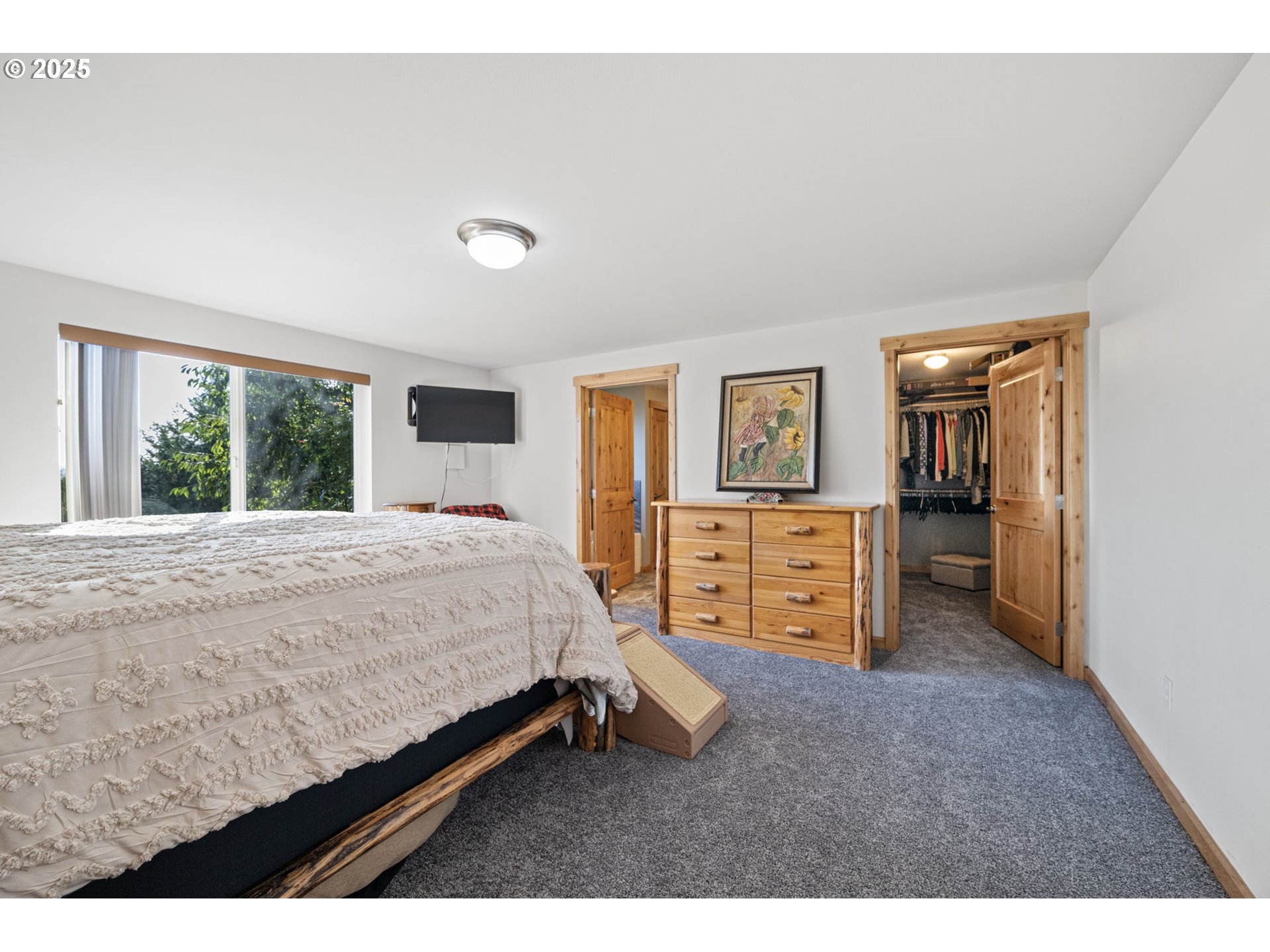 24674 Bolton Hill Road Veneta, OR 97487 - Photo 24 of 48 a bed room with a bed and a television