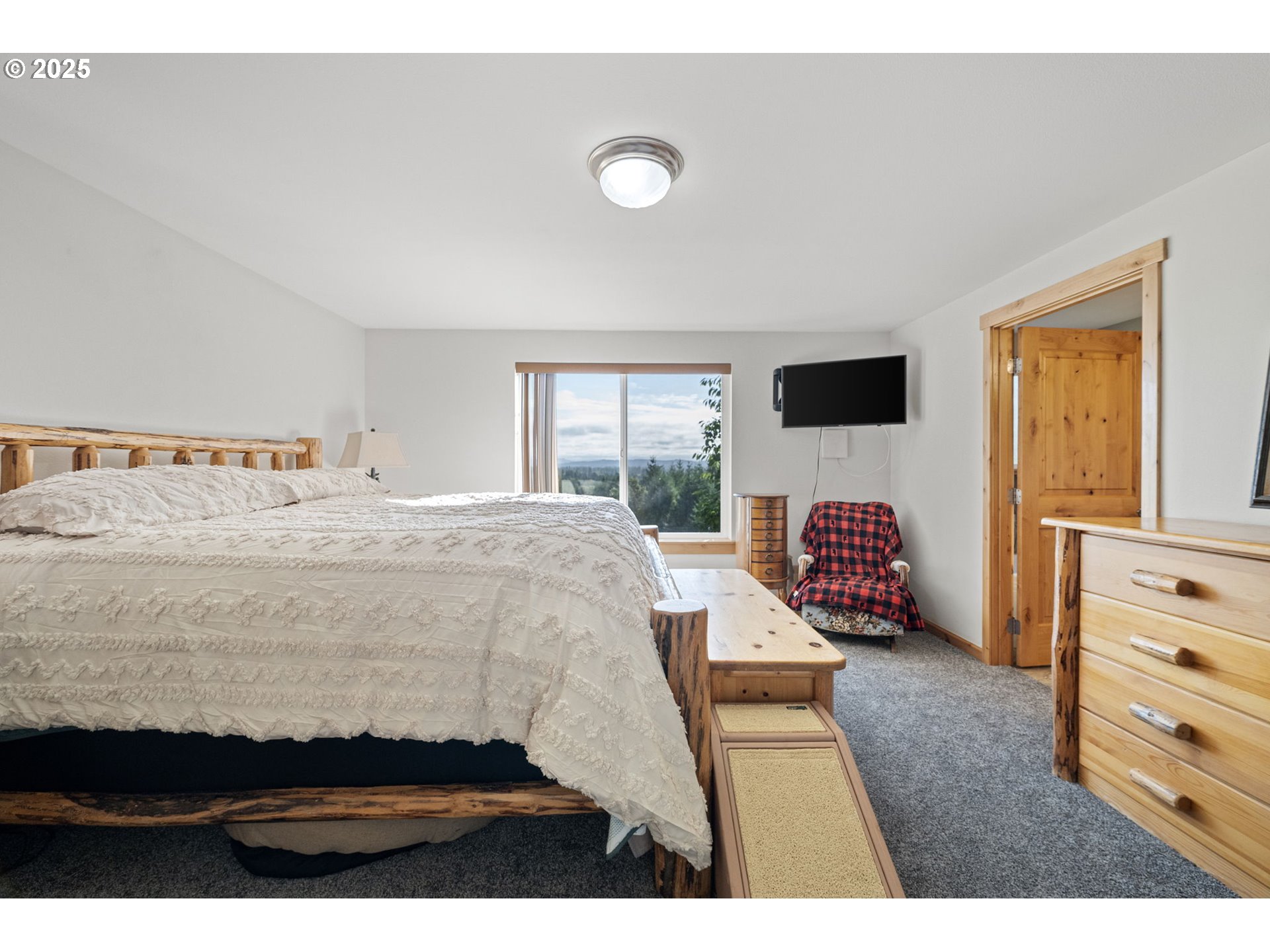 24674 Bolton Hill Road Veneta, OR 97487 - Photo 25 of 48 a bedroom with a bed and a flat screen tv