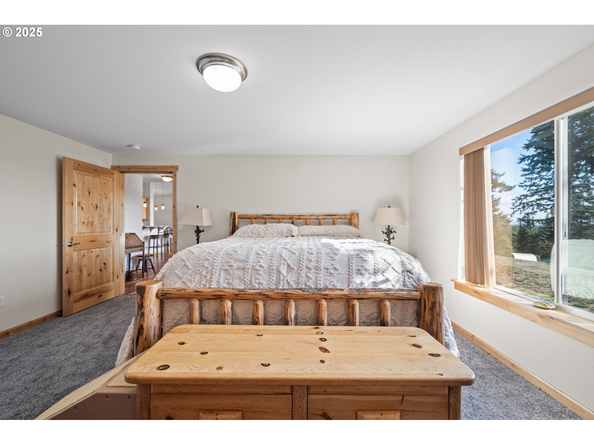 24674 Bolton Hill Road Veneta, OR 97487 - Photo 26 of 48 a bedroom with a bed and wooden floor