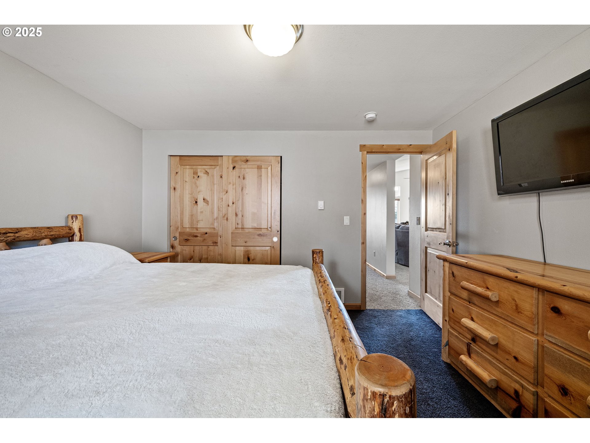 24674 Bolton Hill Road Veneta, OR 97487 - Photo 30 of 48 a bedroom with a bed and a flat screen tv