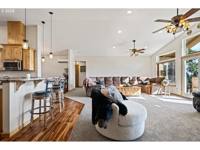 a living room with lots of furniture and a large window