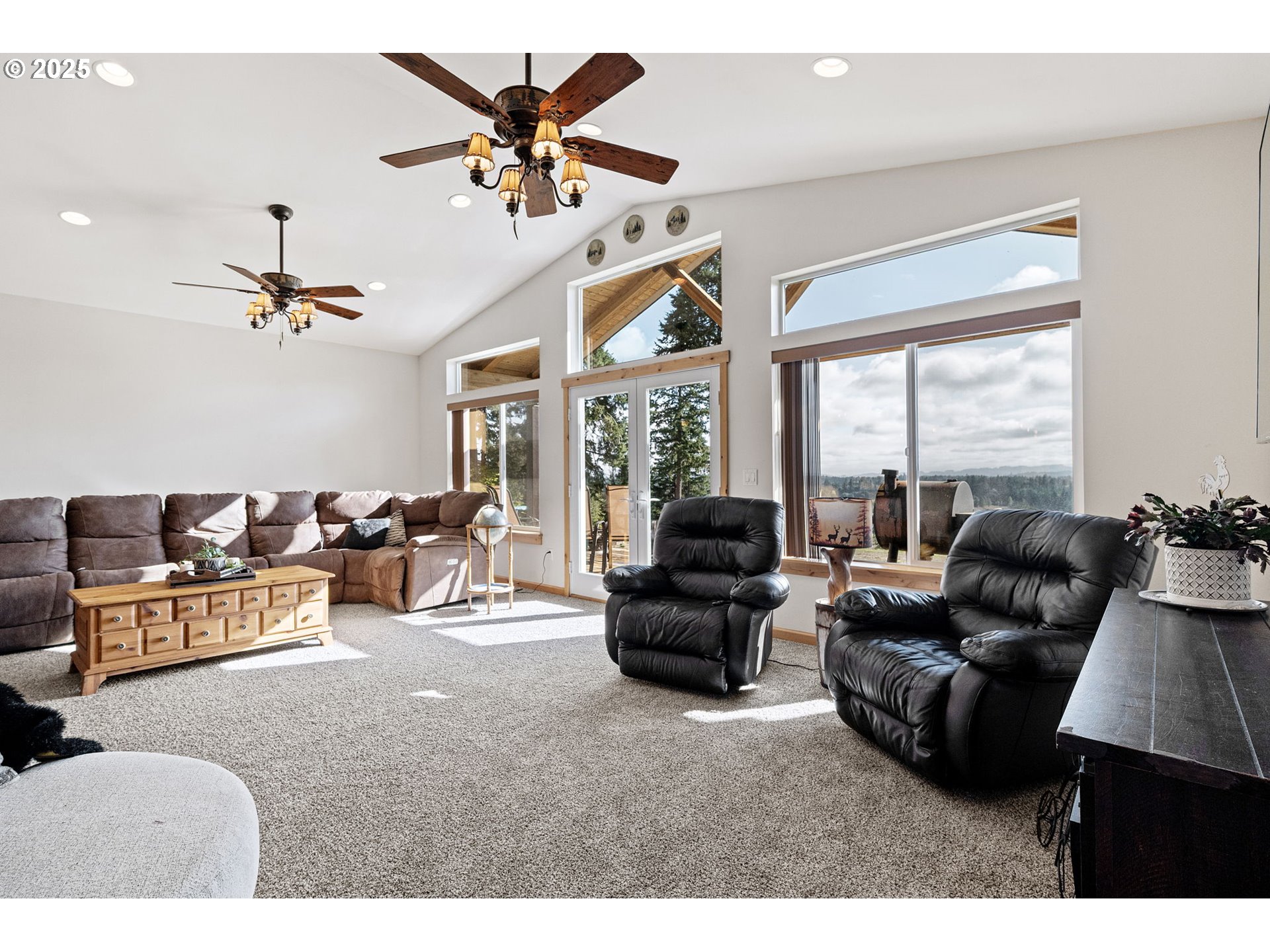 24674 Bolton Hill Road Veneta, OR 97487 - Photo 9 of 48 a living room with furniture ceiling fan and a large window
