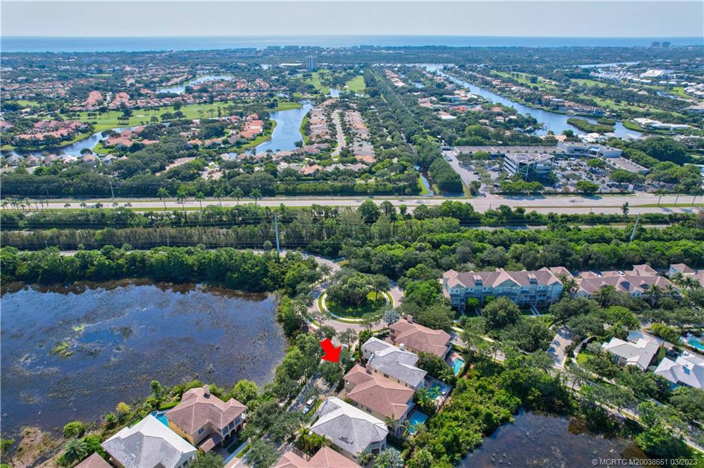 112 Tulip Tree Court Jupiter, FL 33458 - Photo 19 of 76 an aerial view of a city with lots of residential buildings and mountain view in back