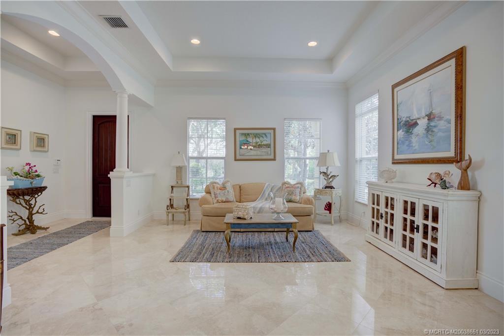 112 Tulip Tree Court Jupiter, FL 33458 - Photo 40 of 76 a living room with furniture and paintings on the wall