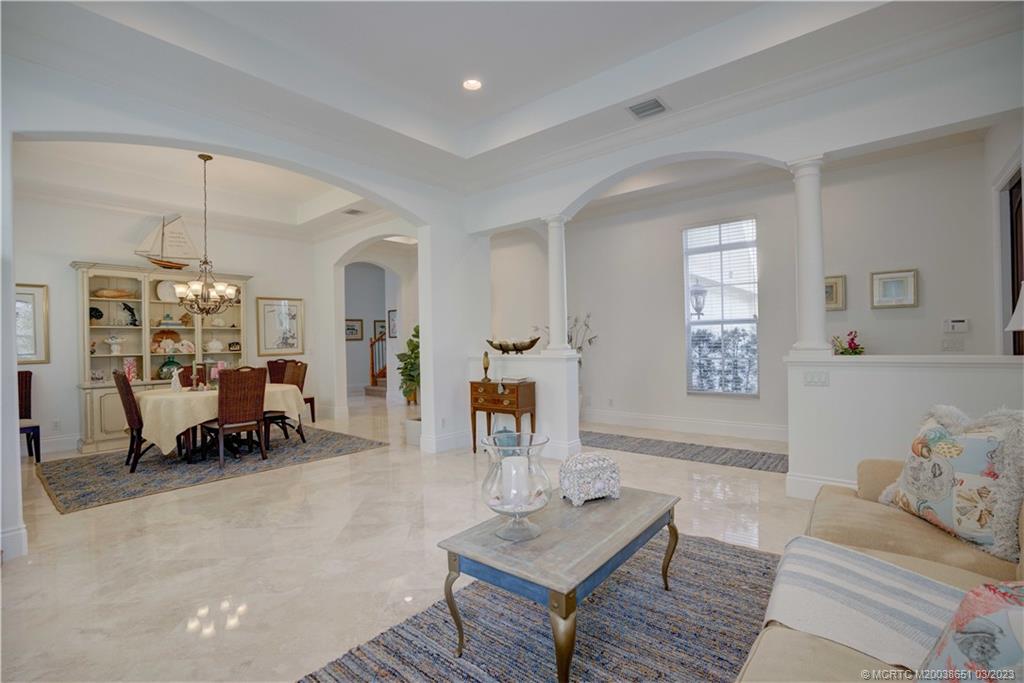 112 Tulip Tree Court Jupiter, FL 33458 - Photo 43 of 76 a living room with furniture and a chandelier