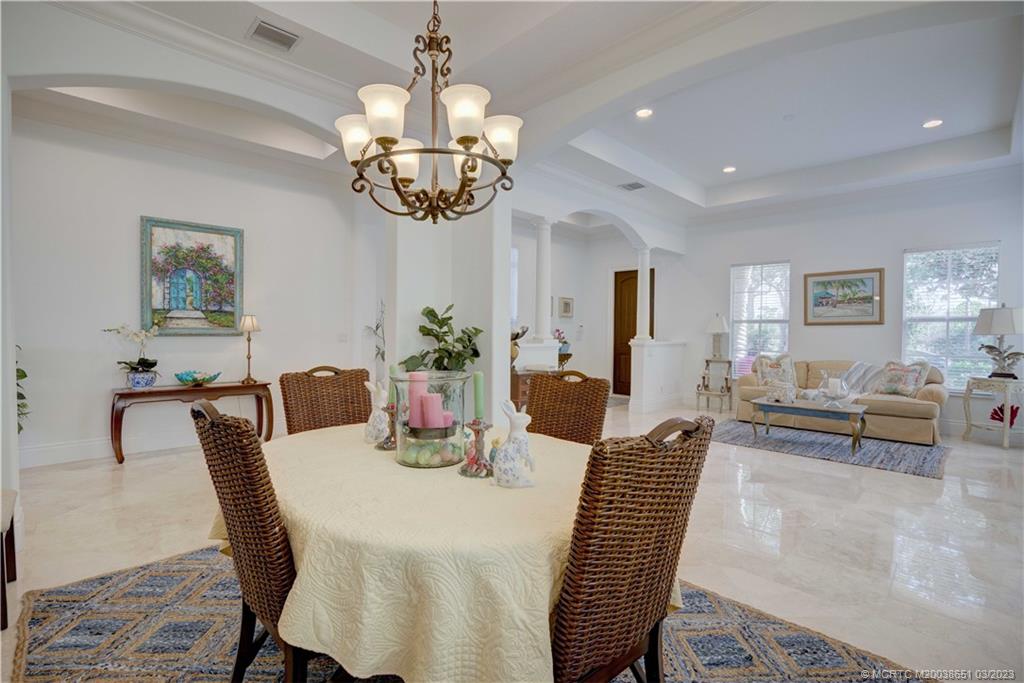 112 Tulip Tree Court Jupiter, FL 33458 - Photo 45 of 76 a view of a dining room with furniture a chandelier and wooden floor
