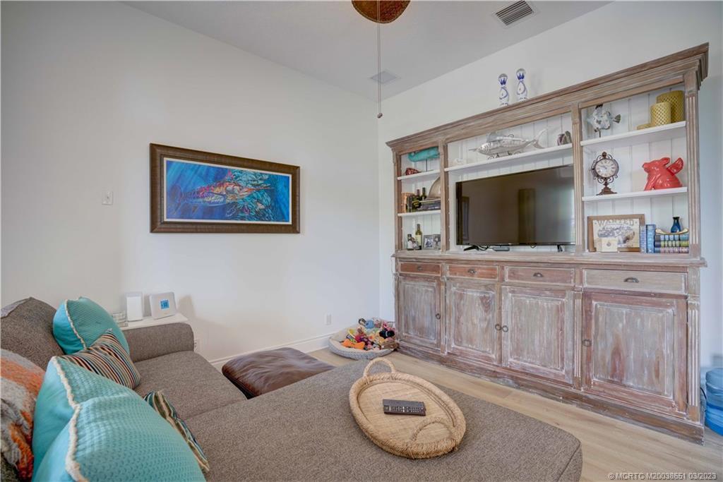112 Tulip Tree Court Jupiter, FL 33458 - Photo 50 of 76 a living room with furniture and a flat screen tv