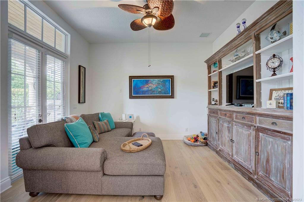 112 Tulip Tree Court Jupiter, FL 33458 - Photo 51 of 76 a living room with furniture and a flat screen tv