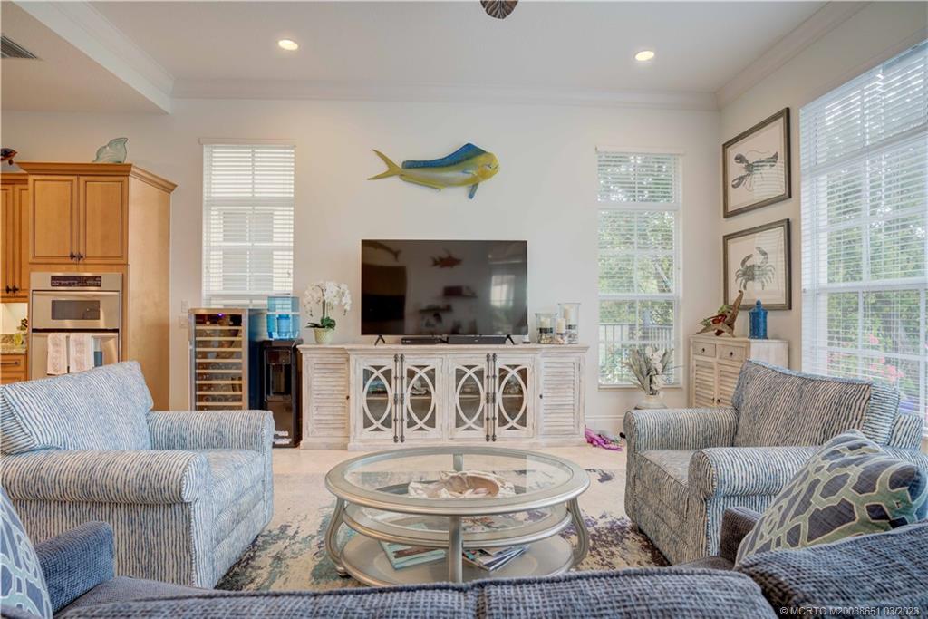 112 Tulip Tree Court Jupiter, FL 33458 - Photo 52 of 76 a living room with furniture and a flat screen tv