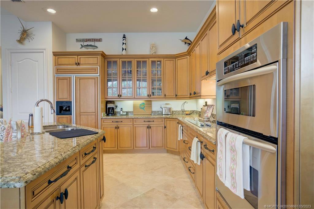 112 Tulip Tree Court Jupiter, FL 33458 - Photo 54 of 76 a kitchen with granite countertop a sink stove and refrigerator