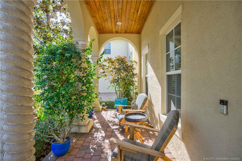 112 Tulip Tree Court Jupiter, FL 33458 - Photo 6 of 76 a view of a house with sitting area and potted plants