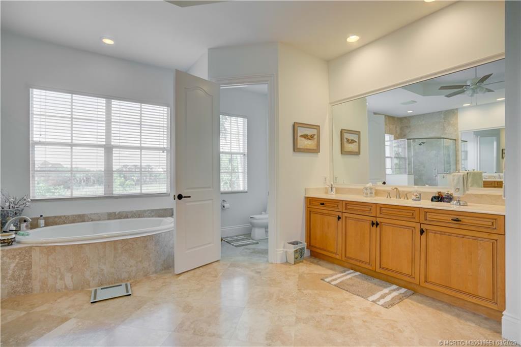 112 Tulip Tree Court Jupiter, FL 33458 - Photo 61 of 76 a spacious bathroom with a double vanity sink a mirror and a bathtub