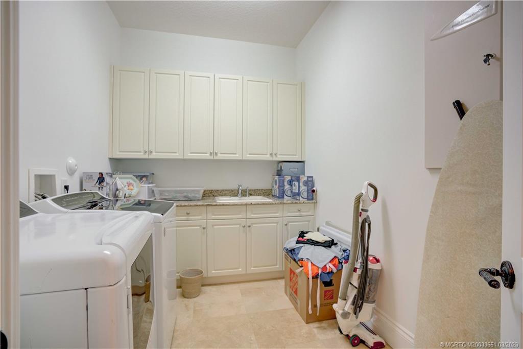 112 Tulip Tree Court Jupiter, FL 33458 - Photo 66 of 76 a view of a storage and utility room with a sink dryer and washer
