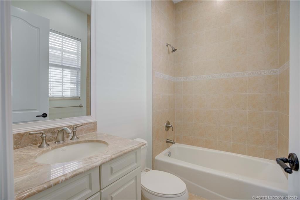 112 Tulip Tree Court Jupiter, FL 33458 - Photo 73 of 76 a bathroom with a granite countertop sink toilet and bathtub