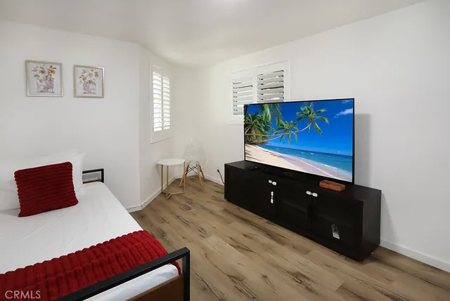 a bedroom with two bed and a closet