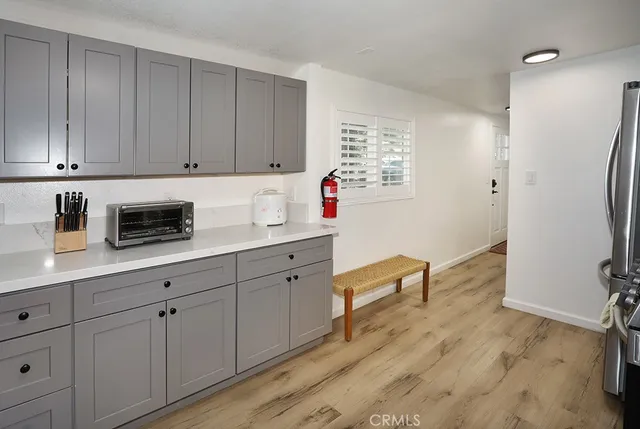 a kitchen with stainless steel appliances granite countertop a sink a stove and cabinets