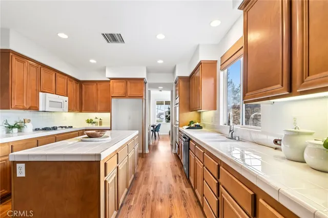 a kitchen with stainless steel appliances a sink stove and cabinets