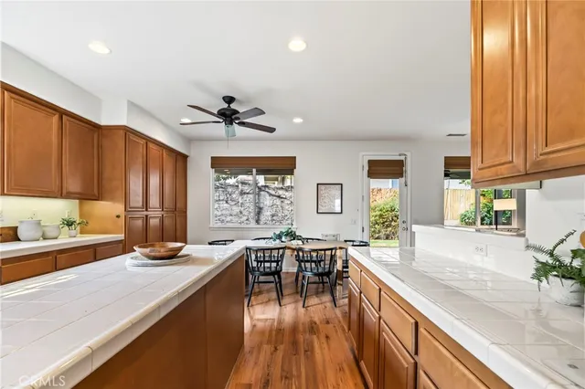a kitchen with granite countertop lots of counter top space and wooden floor