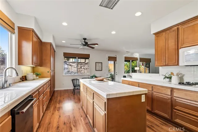 a kitchen with a sink stove and wooden cabinets