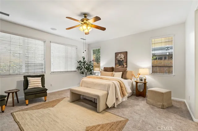 a bedroom with a large bed and a chandelier