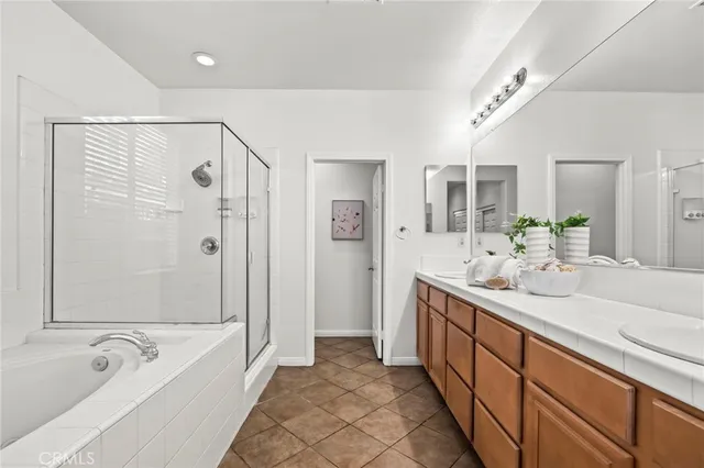 a spacious bathroom with a bathtub shower sink and mirror