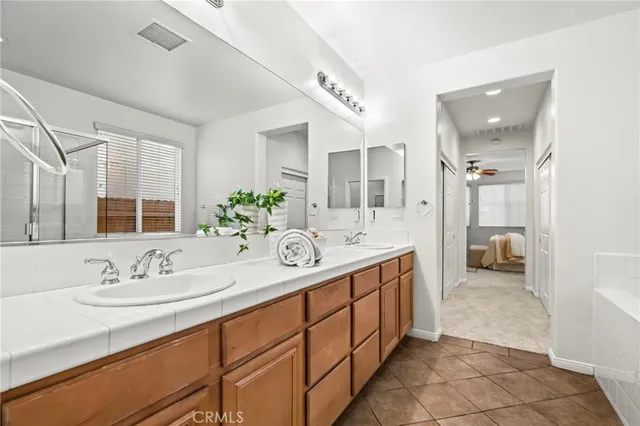 a spacious bathroom with a double vanity sink and a mirror