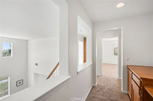 a view of an entryway with wooden floor and a livingroom