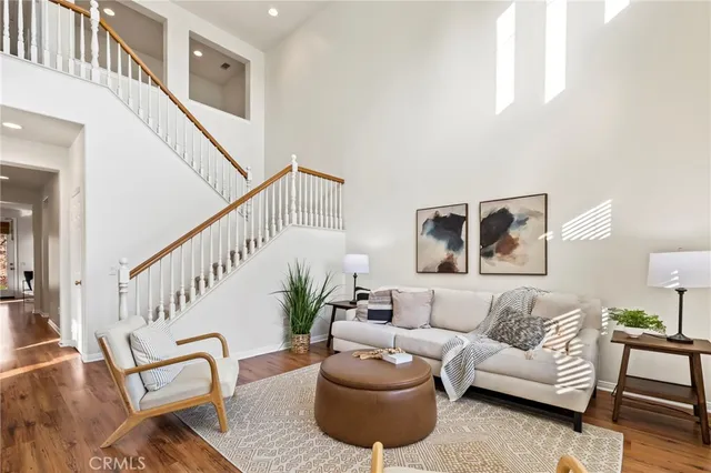 a living room with furniture and stairs
