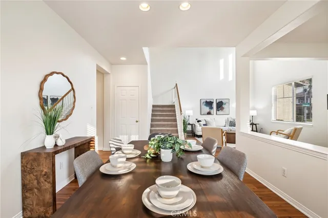 a living room with furniture and a dining room with couches