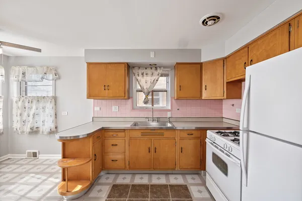 a kitchen with a sink stove and refrigerator