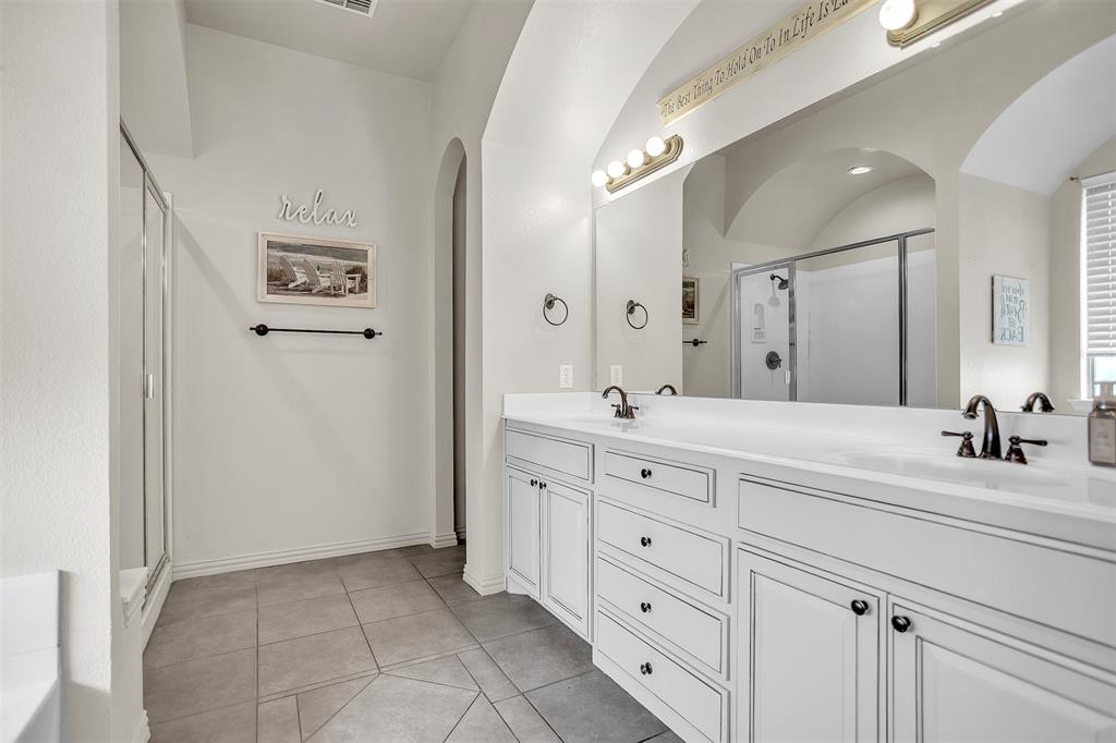 12286 Emerald Ranch Lane North Forney, TX 75126 - Photo 21 of 40 a bathroom with a double vanity sink mirror and