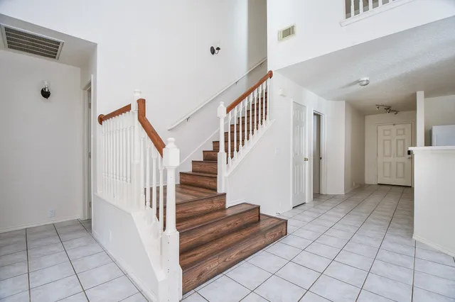 a view of a hallway view with staircase and kitchen view