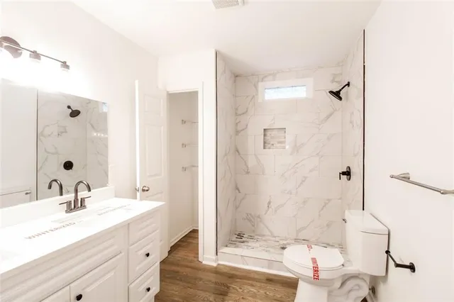 a bathroom with a double vanity sink mirror and shower