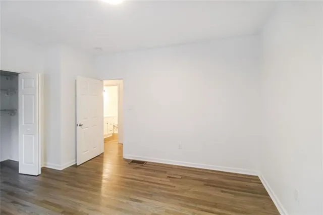 a view of an empty room and wooden floor