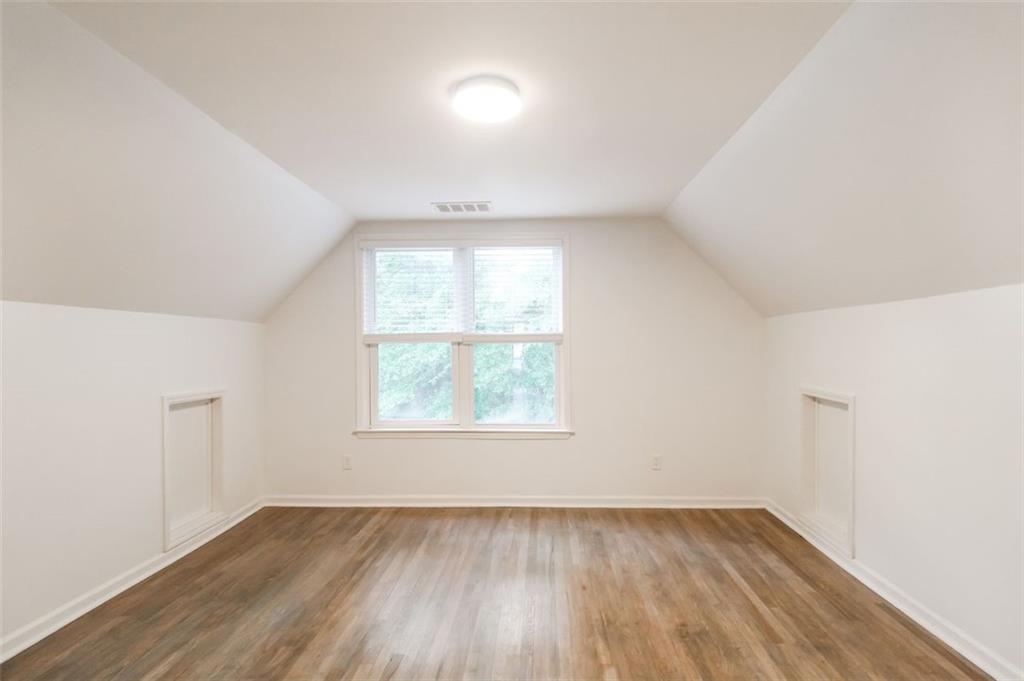1070 4th Street Northwest Atlanta, GA 30318 - Photo 18 of 21 an empty room with wooden floor and windows