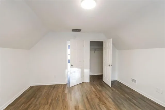 a view of wooden floor and windows in a room