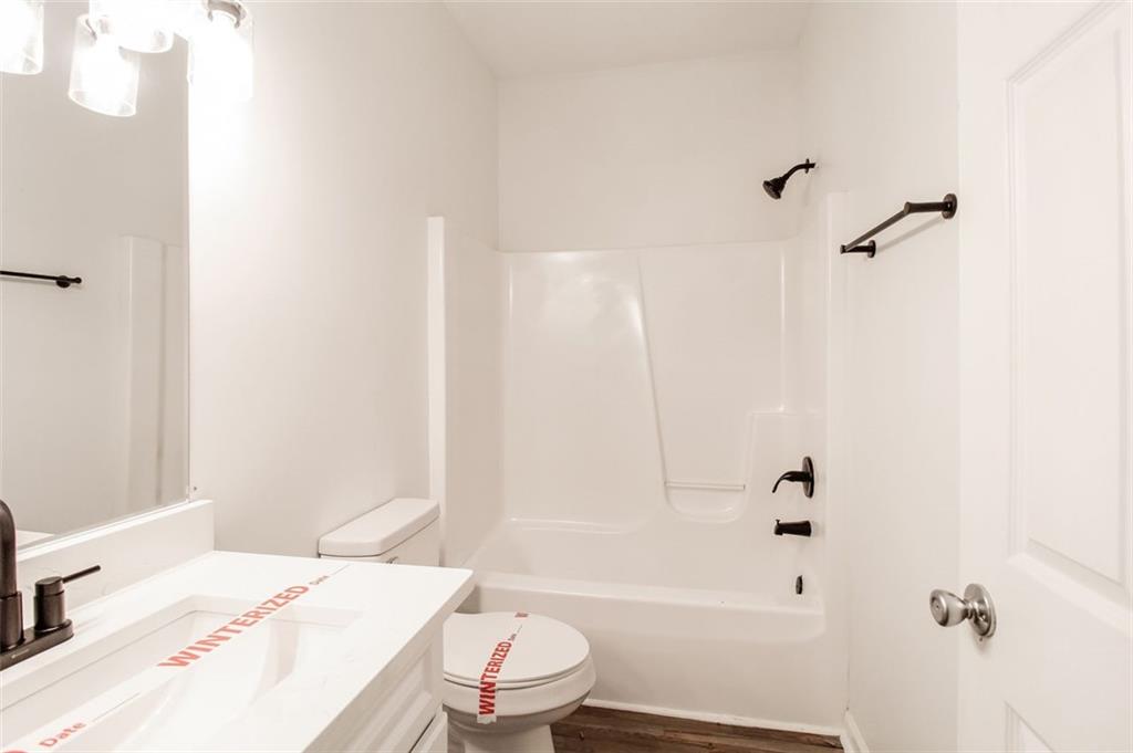 1070 4th Street Northwest Atlanta, GA 30318 - Photo 20 of 21 a bathroom with a sink toilet and shower