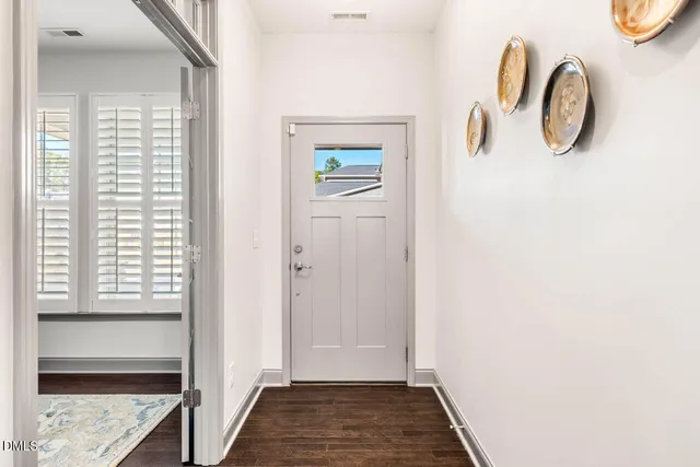 a view of a hallway with wooden floor