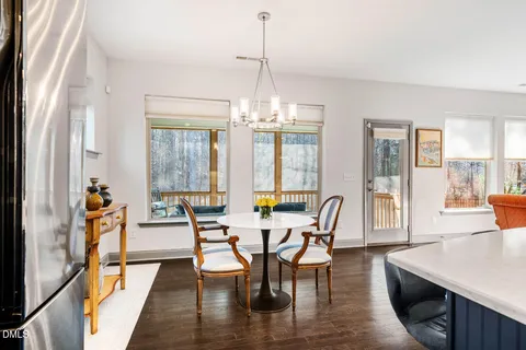 a living room with painting on the wall and a potted plant