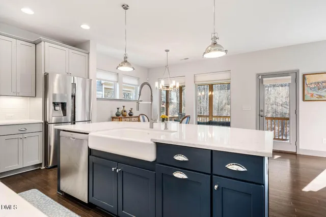 a kitchen with stainless steel appliances granite countertop a sink and a stove