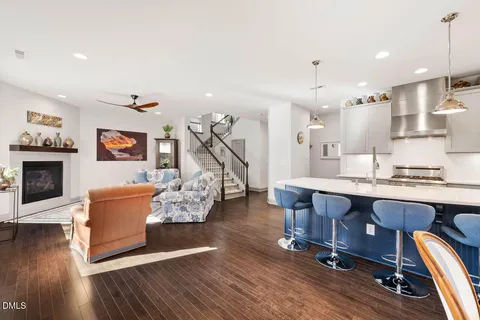 a kitchen with a dining table chairs and refrigerator