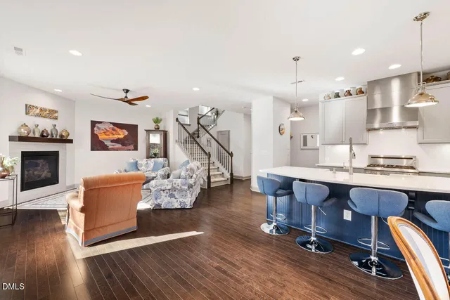 a kitchen with a dining table chairs and refrigerator