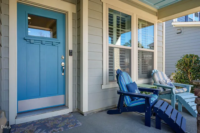 a view of a porch with a table and chairs