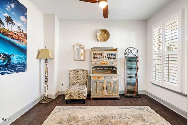 a view of a livingroom with wooden floor and a window