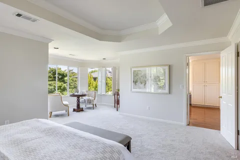 a large white kitchen with a large window