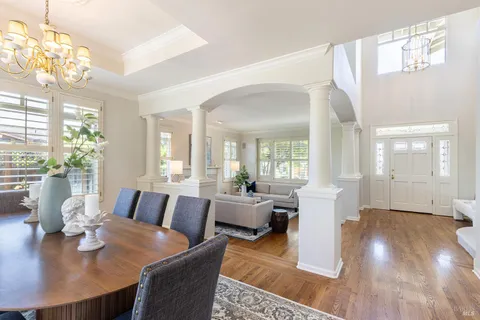 a view of a dining room with furniture wooden floor and chandelier