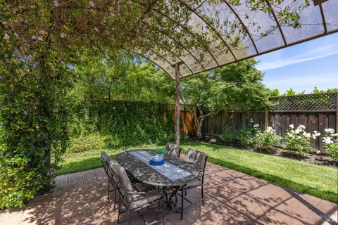 a view of a house with backyard and sitting area