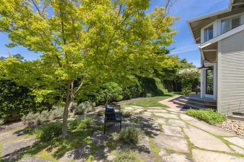 a view of a house with backyard and sitting area