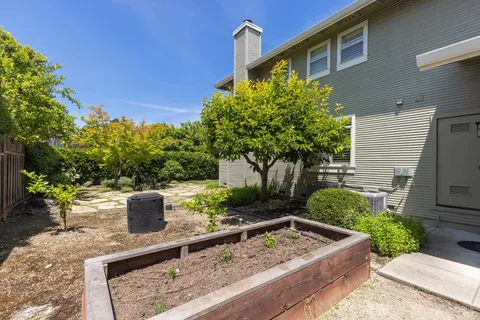 a front view of a house with a garden