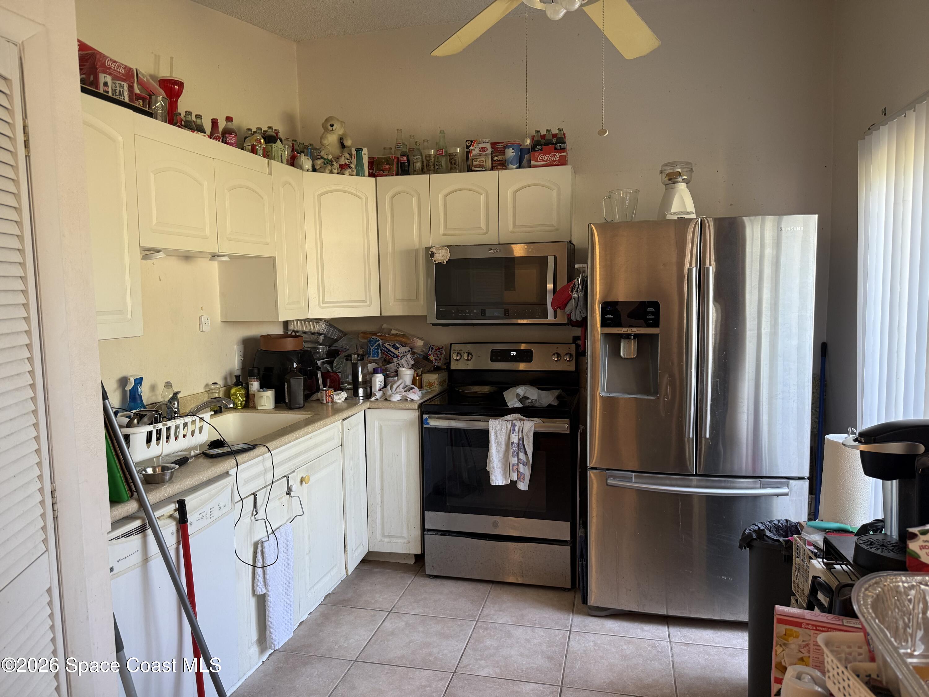 1490 Malibu Circle Northeast, Unit 112 Palm Bay, FL 32905 - Photo 2 of 6 a kitchen with a refrigerator stove and sink